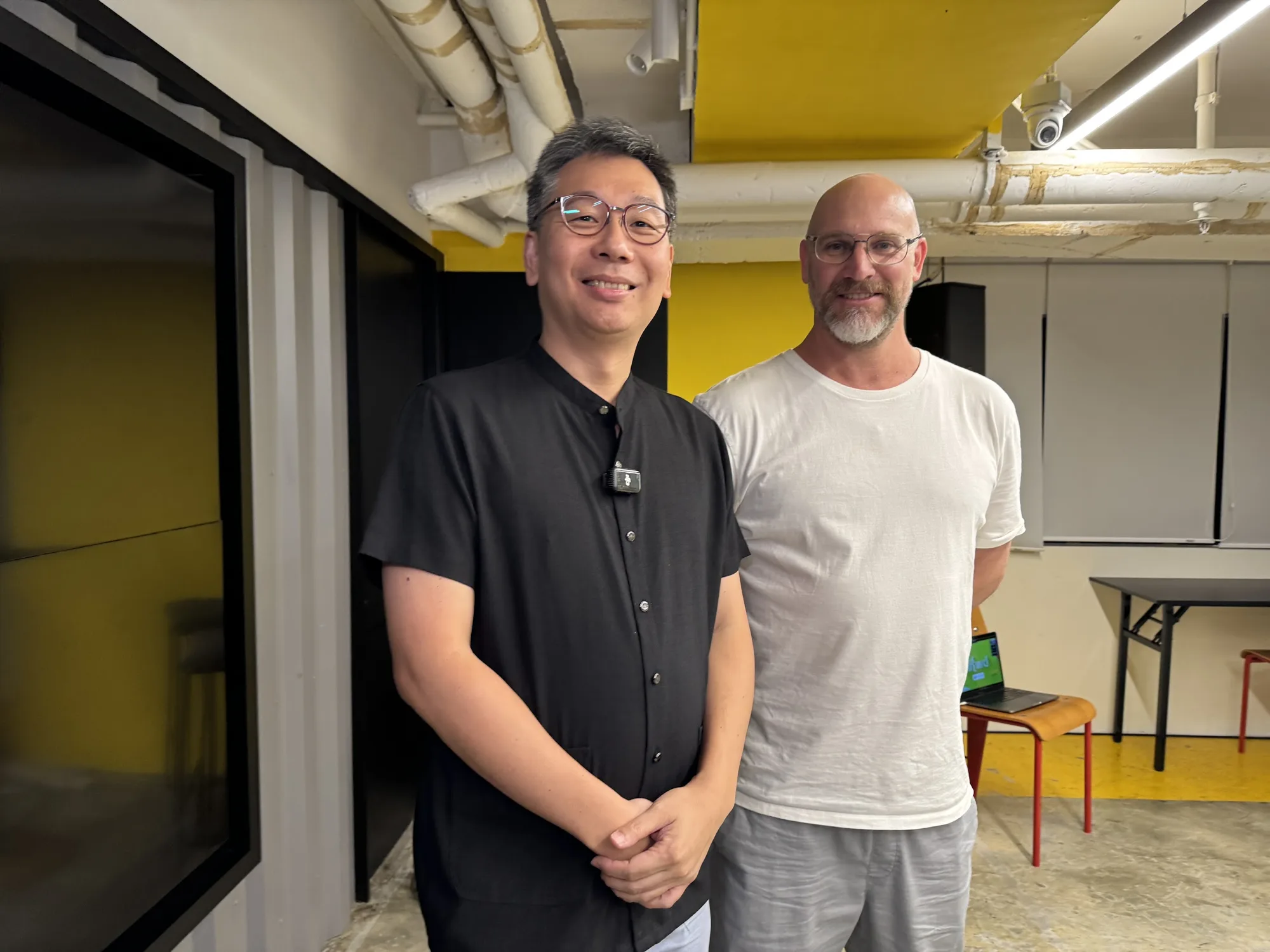Augustin Chan and Rhys Turner standing together before the talk