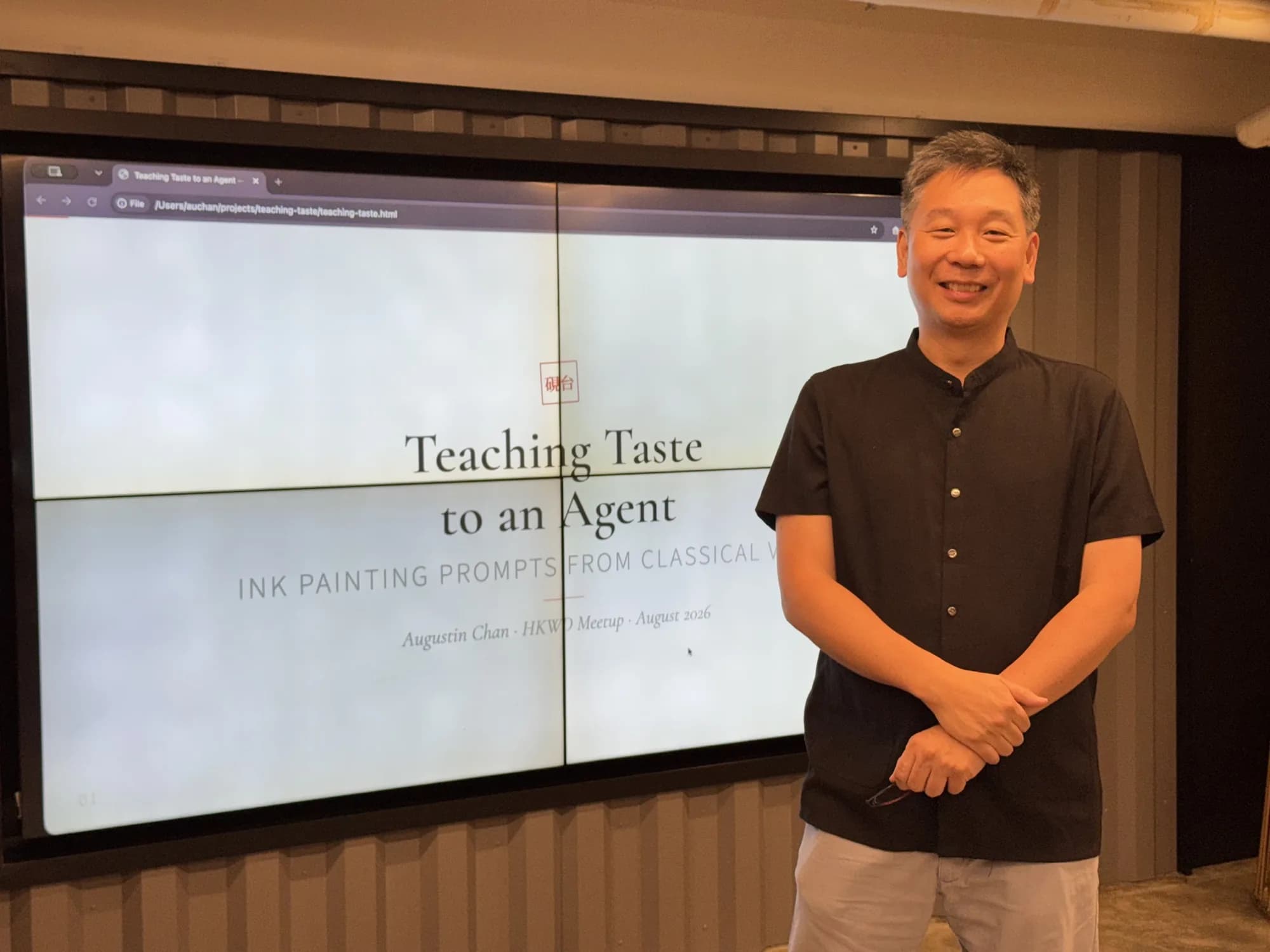 Augustin Chan standing beside a screen reading Teaching Taste to an Agent