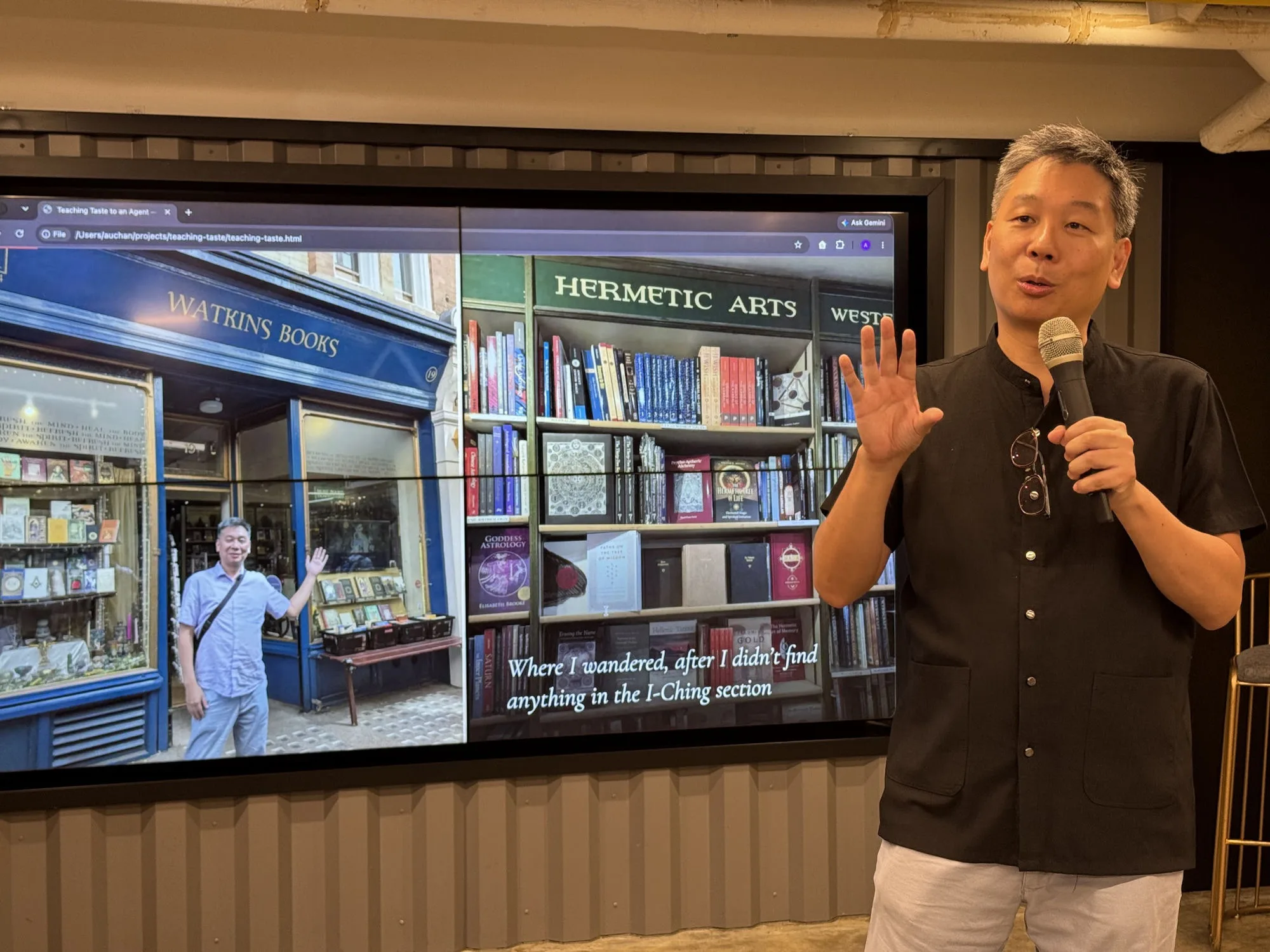 Augustin Chan speaking beside a slide showing the Watkins Books shopfront in London